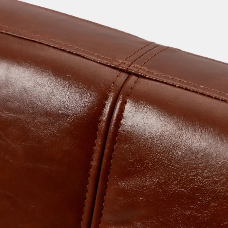 Poltrona in similpelle cognac con struttura in metallo nero - Dudley